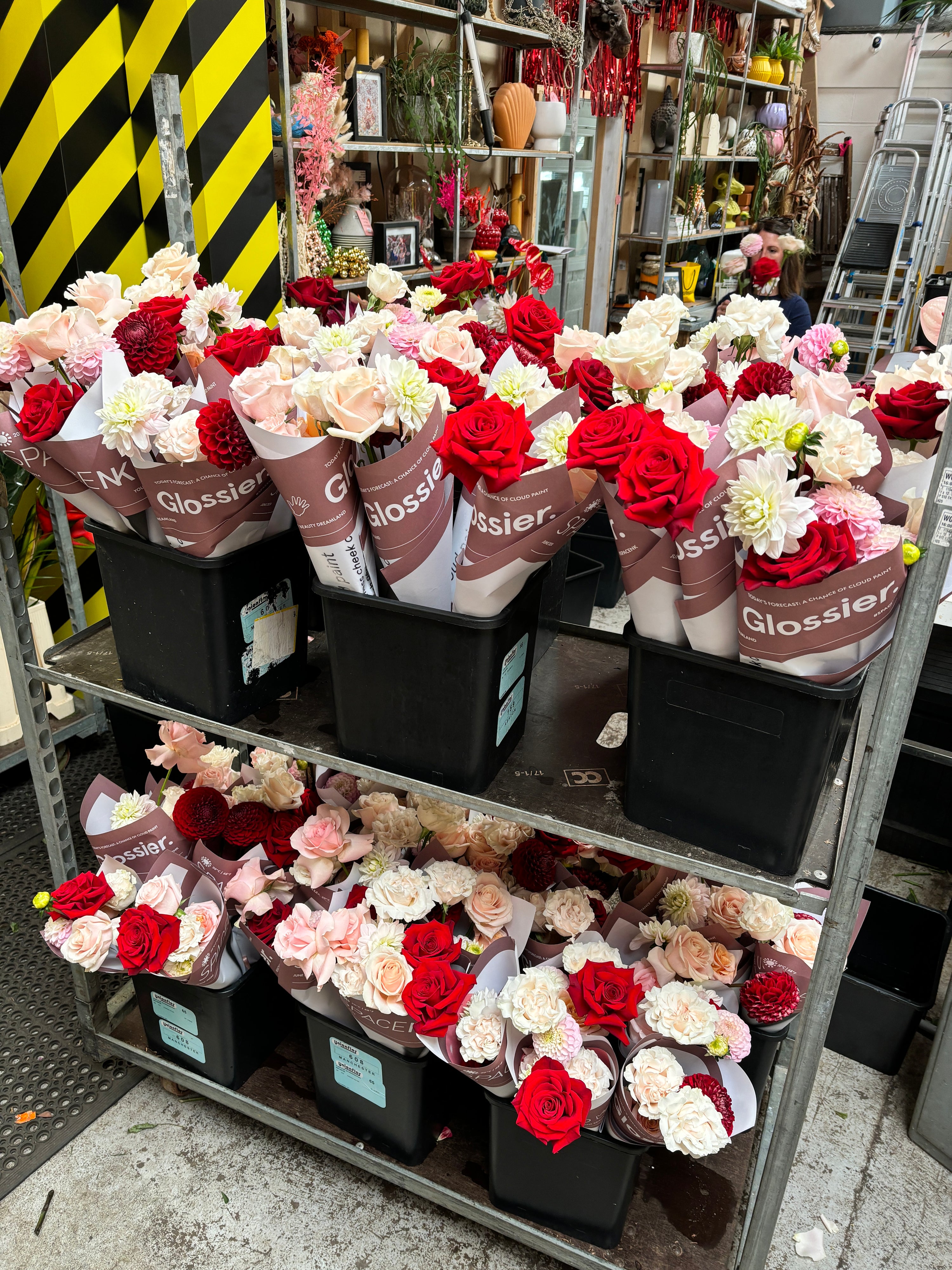 Flower wraps for Glossier Makeup in Manchester. Wraps of red roses, white and pink dahlisa and peach roses. Wrapped in personalised Glossier paper.