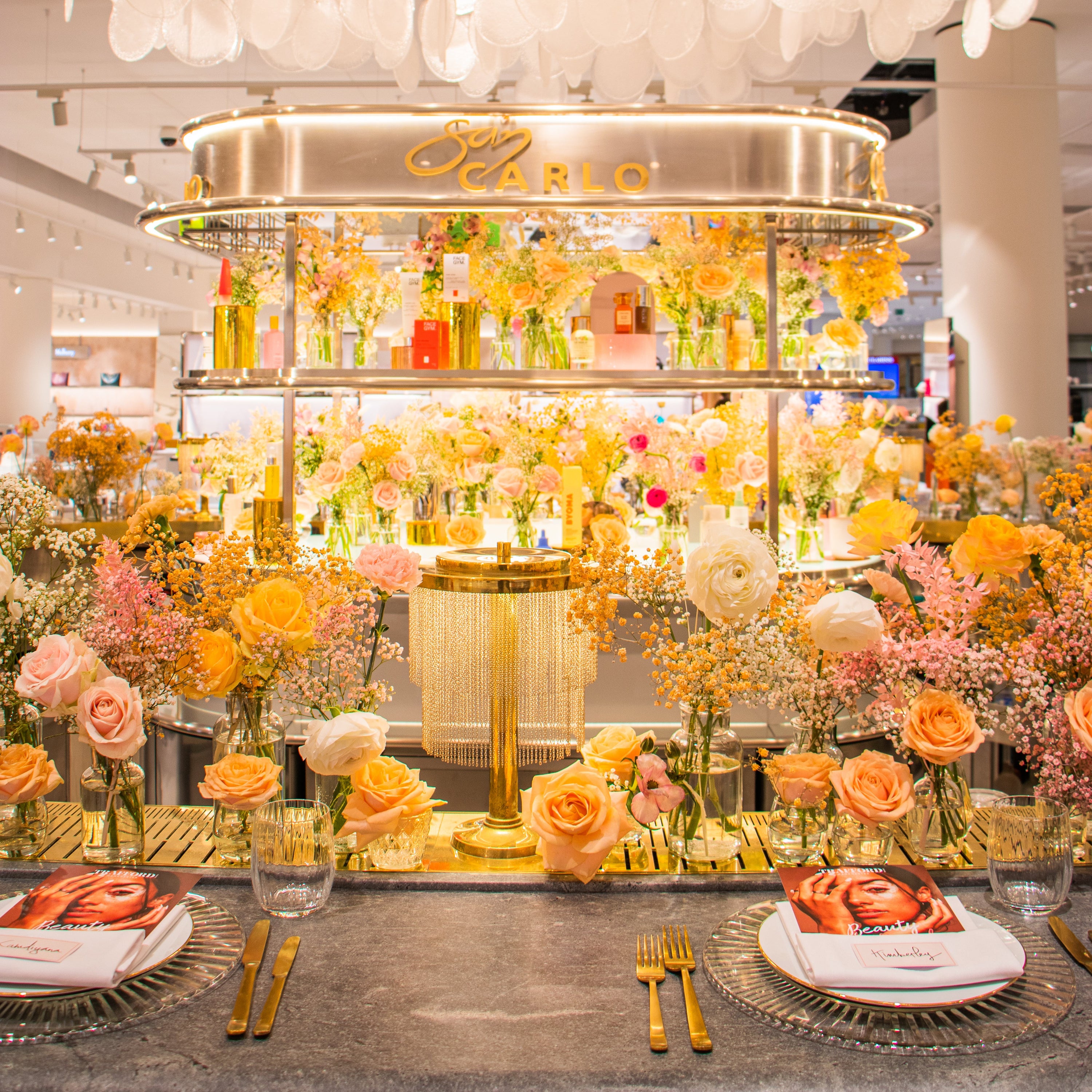 Flowers for a corporate event dinner for San Carlo Restaurant Manchester, in Selfridges Exchange Square. Peach and yellow roses and ranunculus with gypsophila. Alternative, modern and beautiful.
